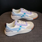 Pair of off-white, lavender and light blue chunky platform sneakers from a three-quarter angle, showing the diagonal blue stripe and ridged midsole