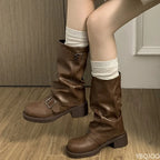 Side profile of brown slouch boot showing full shaft height, lower buckle strap, round toe and stacked block heel