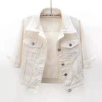 Cropped white denim jacket with spread collar, chest flap pockets and silver snap buttons, shown hanging open