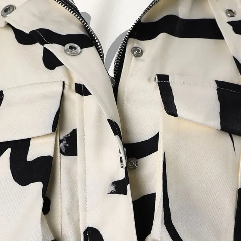 Close-up of the chest area showing the double flap cargo pockets, silver snap buttons and center-front zip on the printed jacket