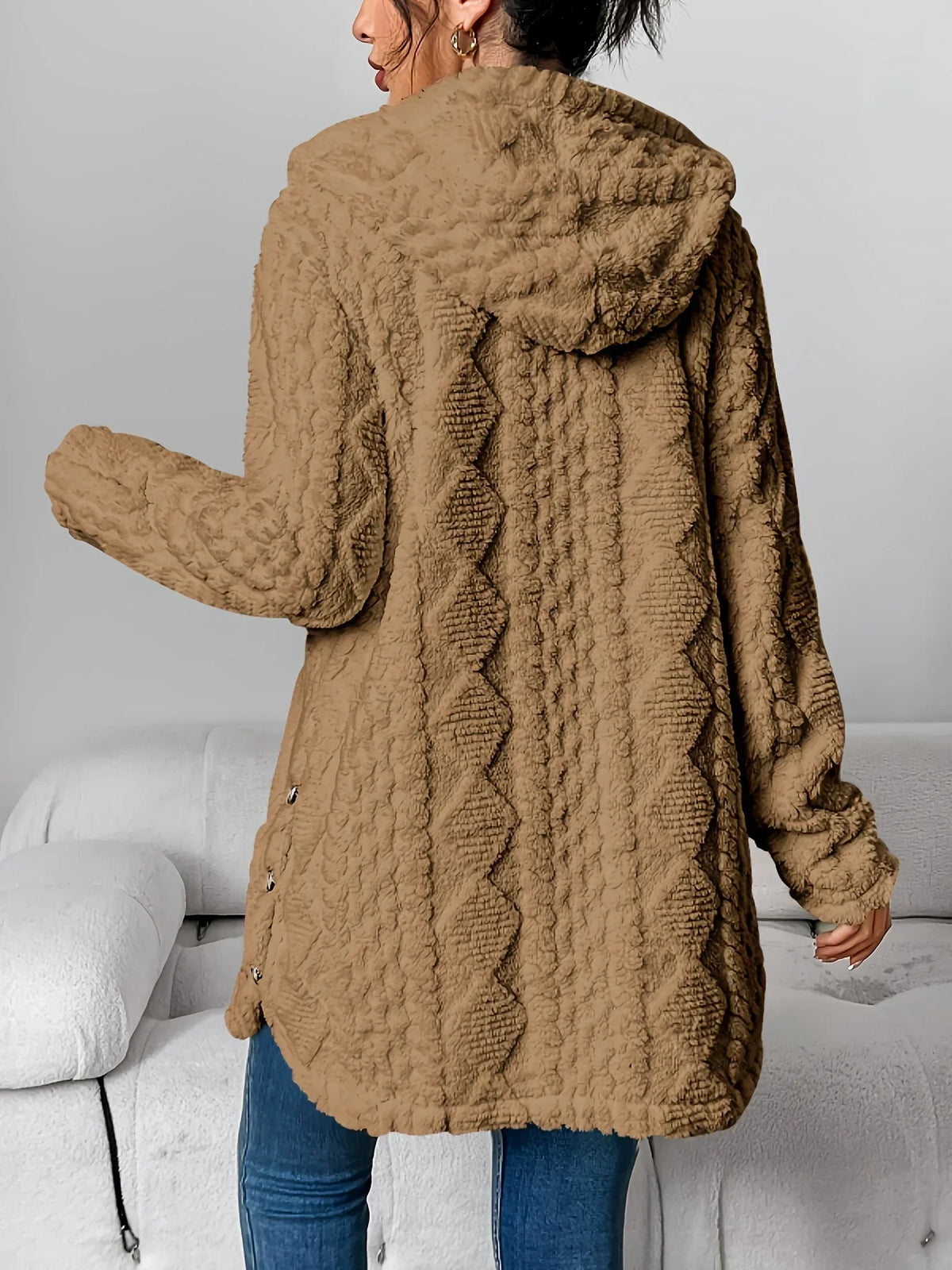 Back view of the camel brown hooded cardigan showing the diamond relief pattern, centre-back seam, hood, relaxed sleeves and button closures at the lower side seams